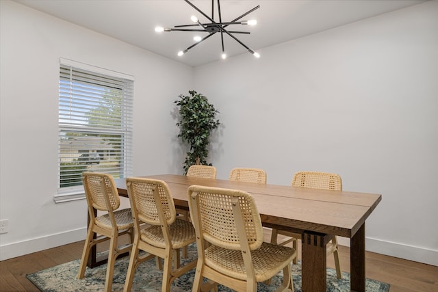 dining space with an inviting chandelier and dark hardwood / wood-style floors