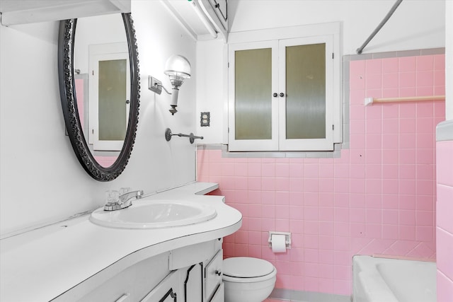 full bathroom with tile walls, vanity, toilet, and bathing tub / shower combination