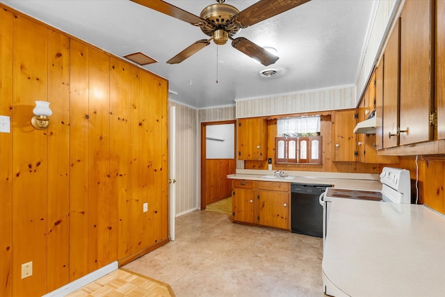 kitchen featuring black dishwasher, a textured ceiling, ceiling fan, wooden walls, and sink