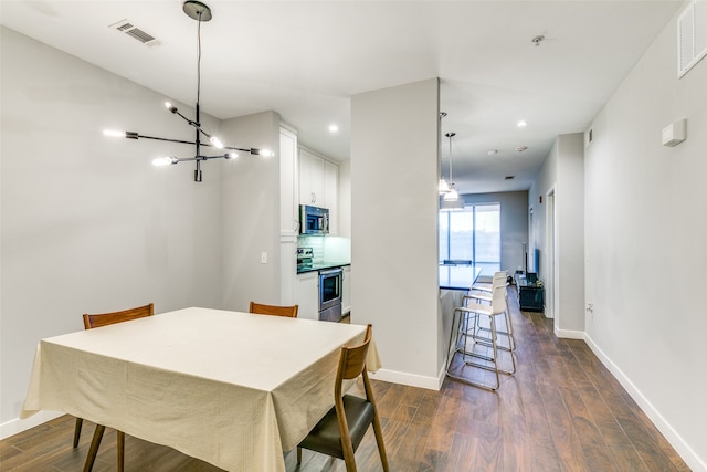 dining space featuring dark wood-type flooring