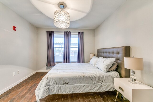 bedroom with dark wood-type flooring