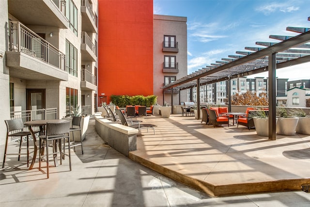 view of patio / terrace featuring a balcony, an outdoor living space, and a pergola