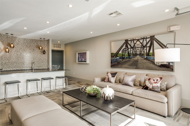 living room featuring light wood-type flooring and sink