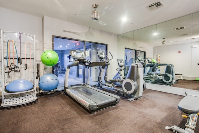 workout area featuring ceiling fan and carpet floors