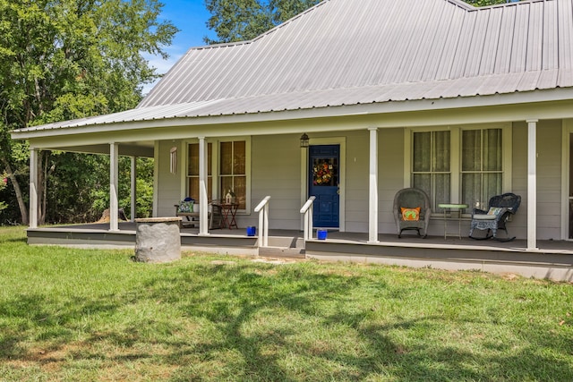 property entrance featuring a yard and covered porch