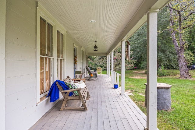 deck with a yard and covered porch