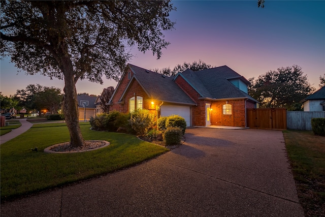 view of front of property featuring a garage and a yard