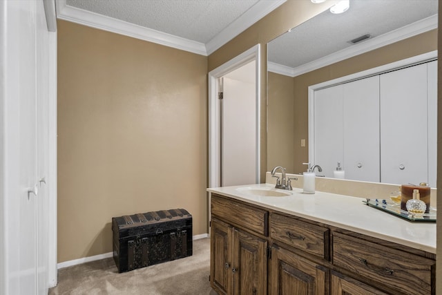 bathroom with vanity, a textured ceiling, and ornamental molding