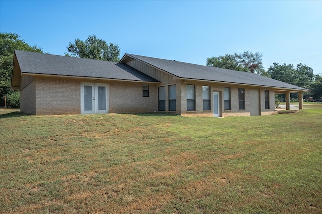 rear view of property with a lawn