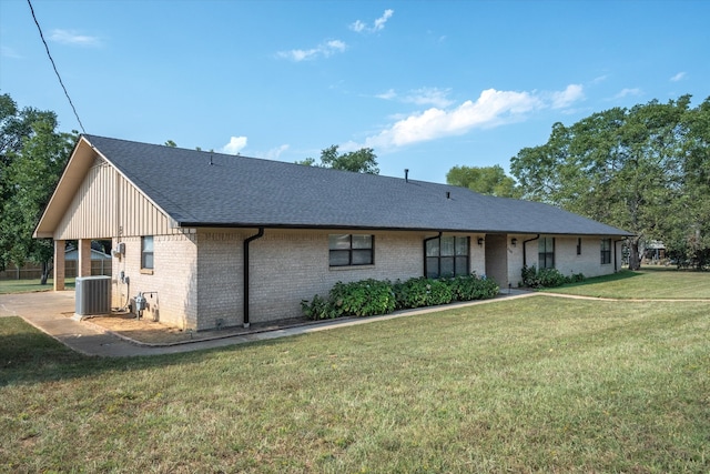 ranch-style house featuring central AC and a front yard