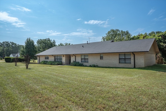 rear view of house featuring a yard