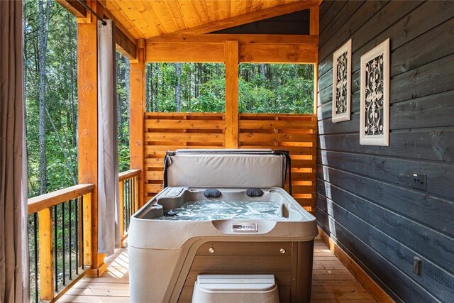 wooden terrace featuring a hot tub