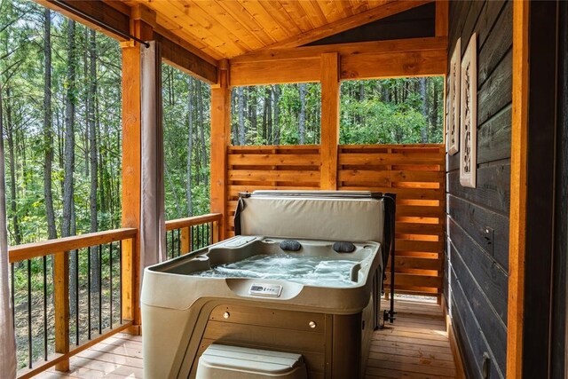 sunroom featuring a jacuzzi, wooden ceiling, and vaulted ceiling