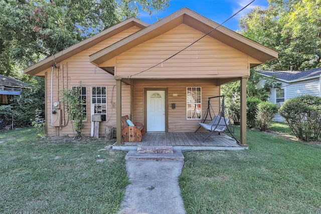 bungalow-style home with a front lawn and covered porch