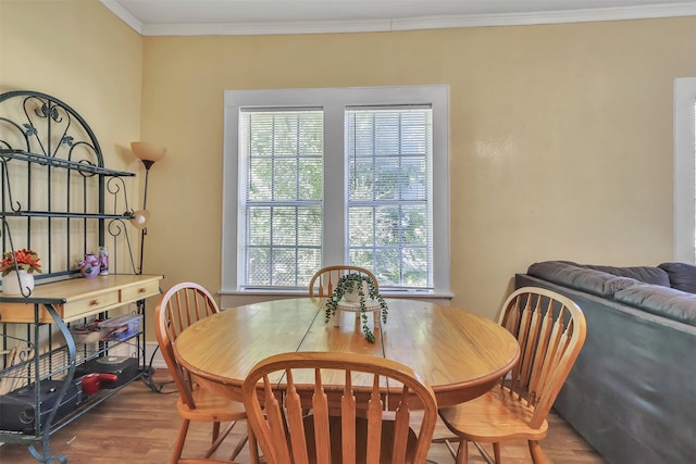 dining room with crown molding and hardwood / wood-style floors