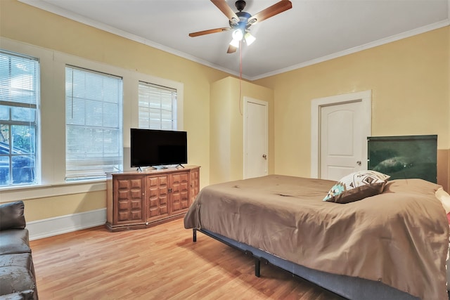 bedroom featuring wood-type flooring, crown molding, and ceiling fan