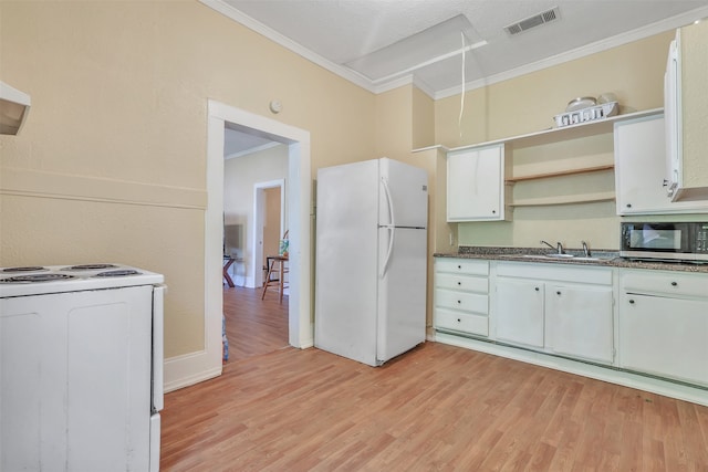 kitchen featuring white cabinets, light wood-type flooring, and white appliances