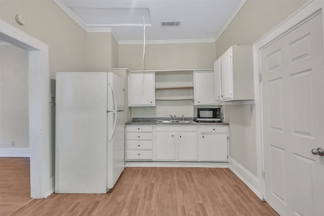 kitchen featuring light wood-type flooring, white refrigerator, sink, white cabinets, and ornamental molding