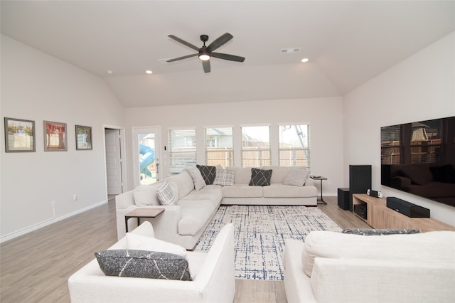 living room with a healthy amount of sunlight, ceiling fan, and light hardwood / wood-style flooring