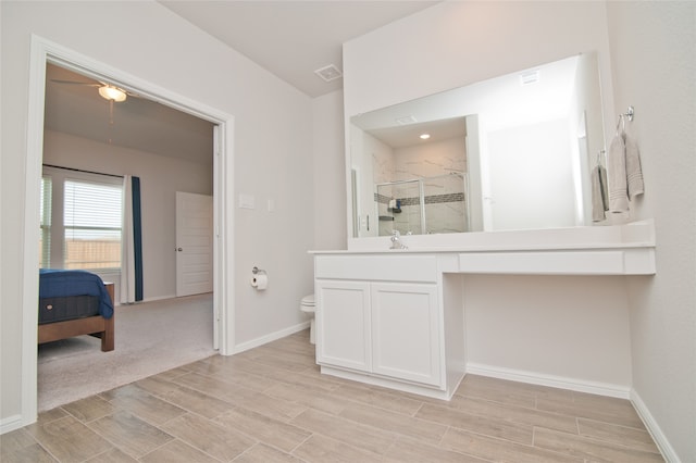 bathroom with vanity, toilet, and an enclosed shower