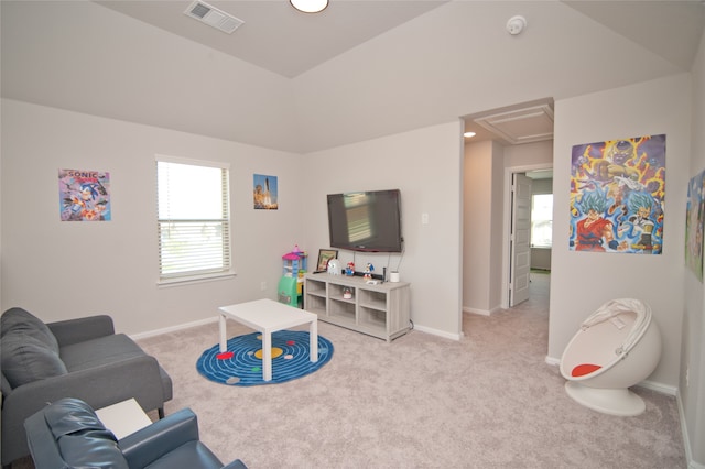 playroom with light carpet and lofted ceiling