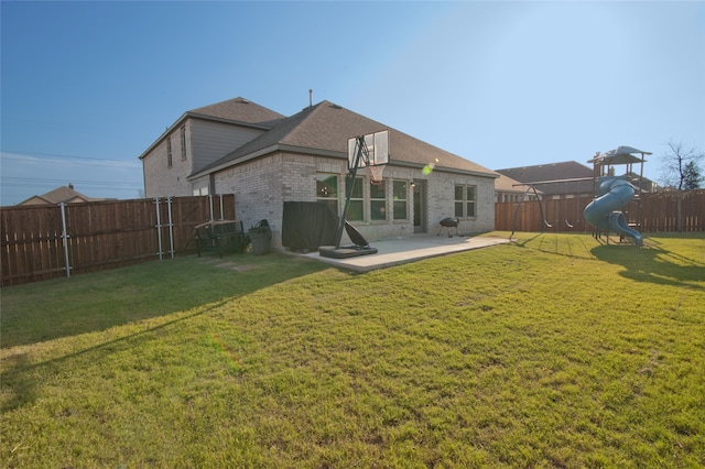 back of property featuring a playground, a lawn, and a patio area