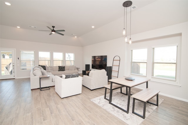 living room featuring ceiling fan, light hardwood / wood-style floors, high vaulted ceiling, and a wealth of natural light