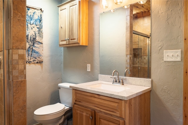 bathroom with walk in shower, vanity, and toilet