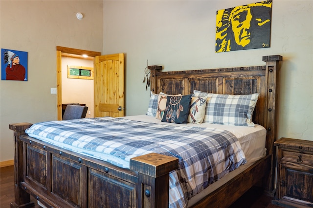 bedroom with dark hardwood / wood-style flooring