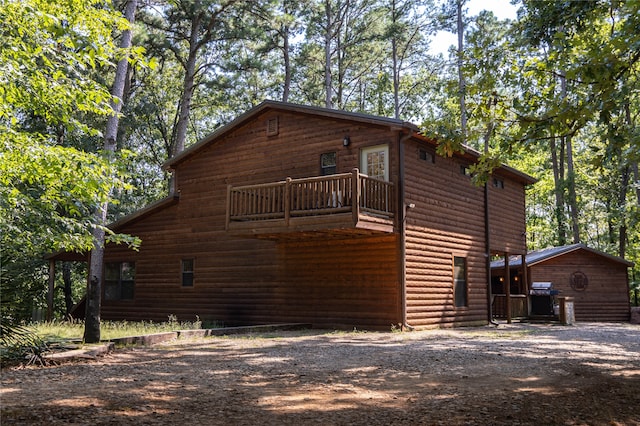 view of side of home featuring a balcony