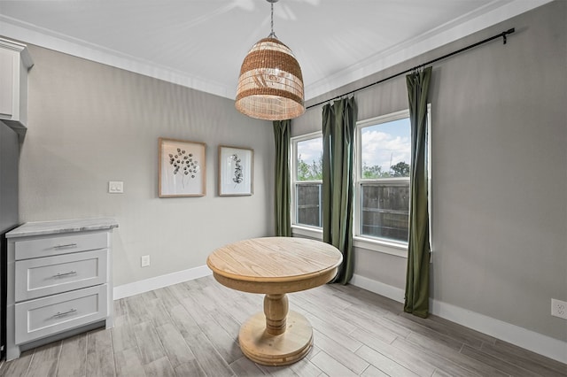 living area featuring light hardwood / wood-style floors and crown molding