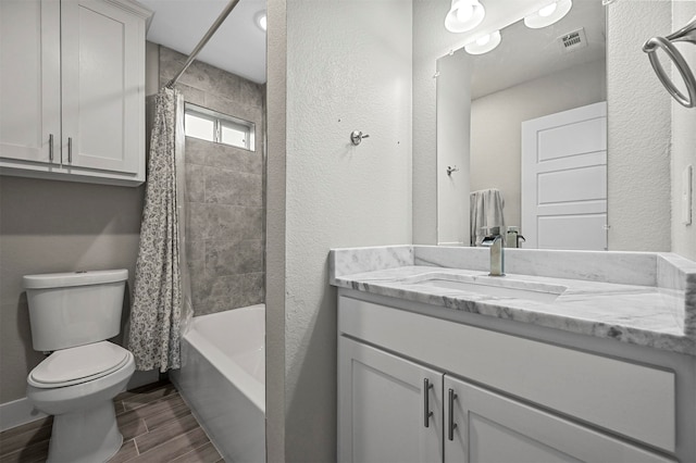 full bathroom with vanity, shower / bath combination with curtain, and toilet