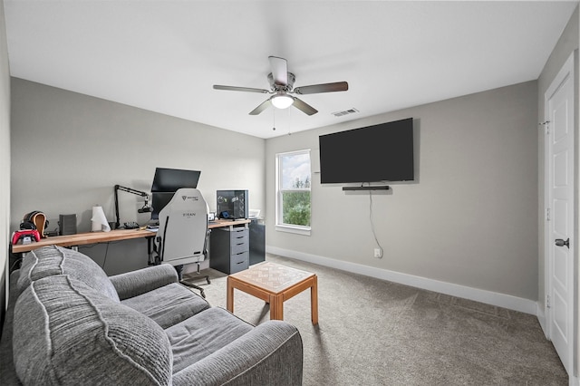 carpeted home office featuring ceiling fan