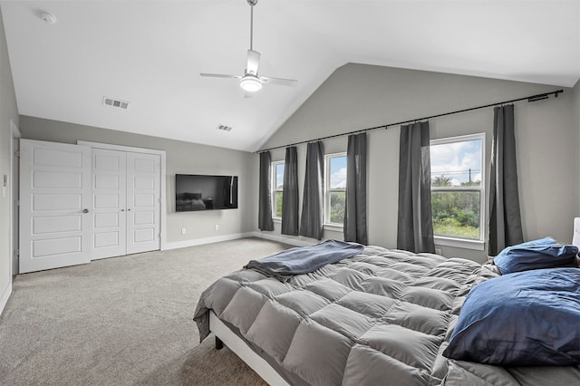 carpeted bedroom with a closet, ceiling fan, and lofted ceiling