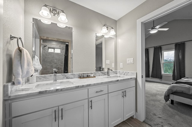 bathroom featuring a shower, vanity, and ceiling fan