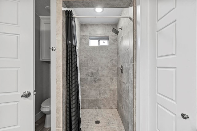 bathroom featuring curtained shower and toilet