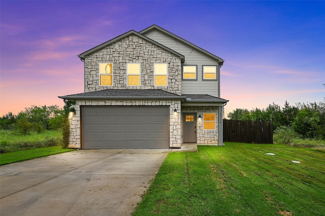 front of property featuring a yard and a garage