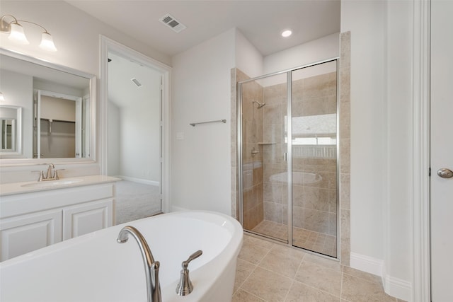 bathroom with independent shower and bath, vanity, and tile patterned flooring