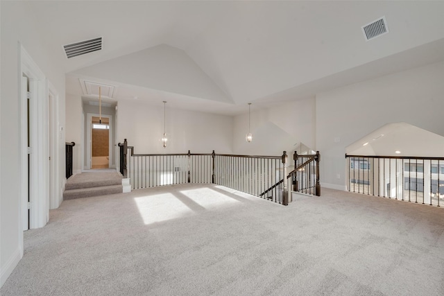 unfurnished room with vaulted ceiling and light colored carpet