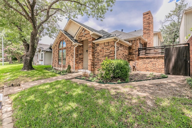 205 Benwynd Dr, Mesquite, TX 75149 - view of front of home featuring brick siding, a chimney, and roof with shingles