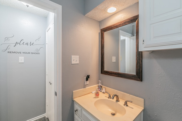 bathroom with vanity and a textured ceiling