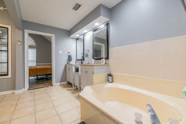 205 Benwynd Dr, Mesquite, TX 75149 - bathroom with vanity, a garden tub, and tile patterned floors