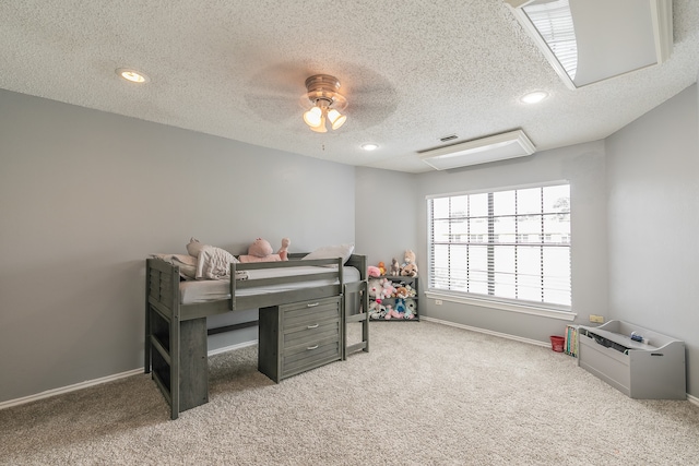 bedroom featuring ceiling fan, a textured ceiling, and light carpet