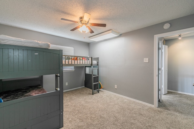 carpeted bedroom with a textured ceiling and ceiling fan