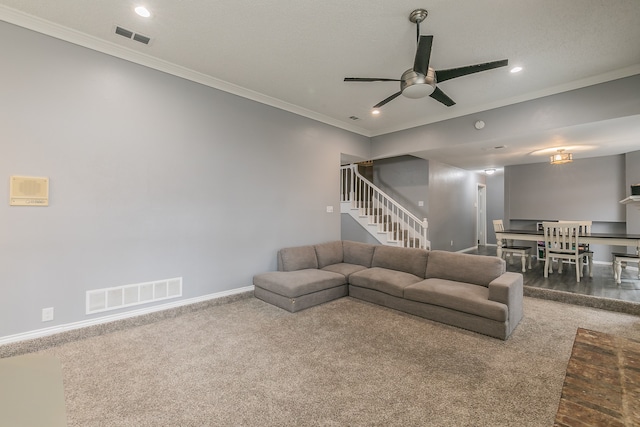 living room with carpet flooring, ceiling fan, and crown molding