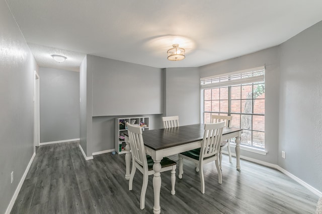 dining room with a textured ceiling, dark hardwood / wood-style flooring, and a healthy amount of sunlight