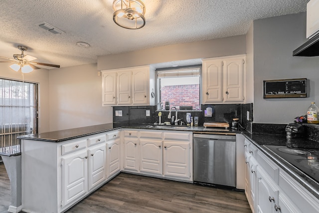 kitchen with dishwasher, kitchen peninsula, sink, dark hardwood / wood-style floors, and white cabinetry