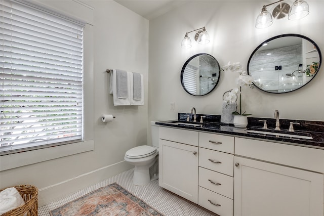 bathroom featuring tile patterned floors, walk in shower, vanity, and toilet