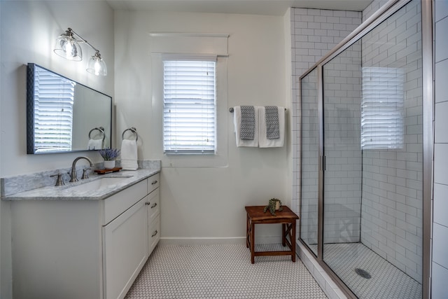 bathroom with tile patterned flooring, vanity, and a shower with door