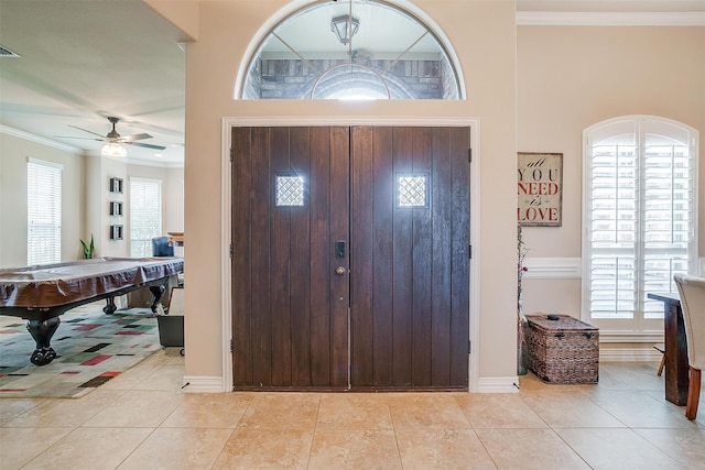 entryway featuring ornamental molding, ceiling fan, light tile patterned floors, and billiards